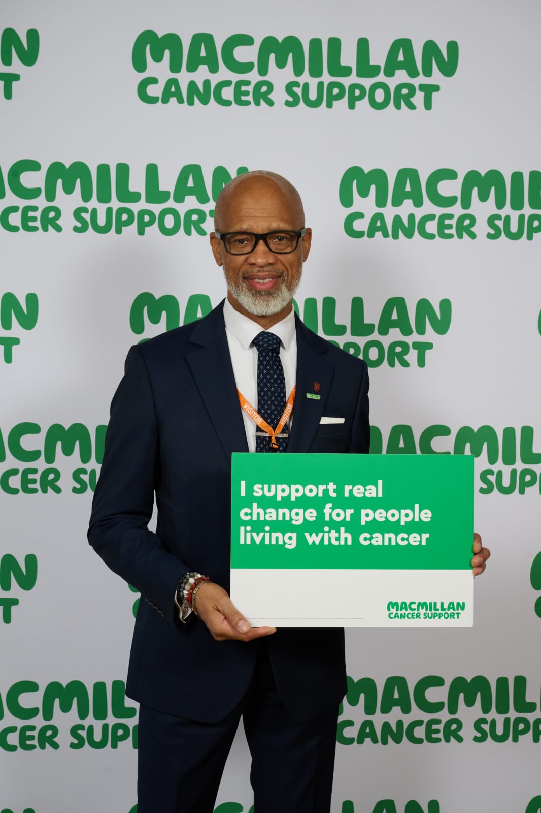 Denzil holding a Macmillan Cancer Support sign